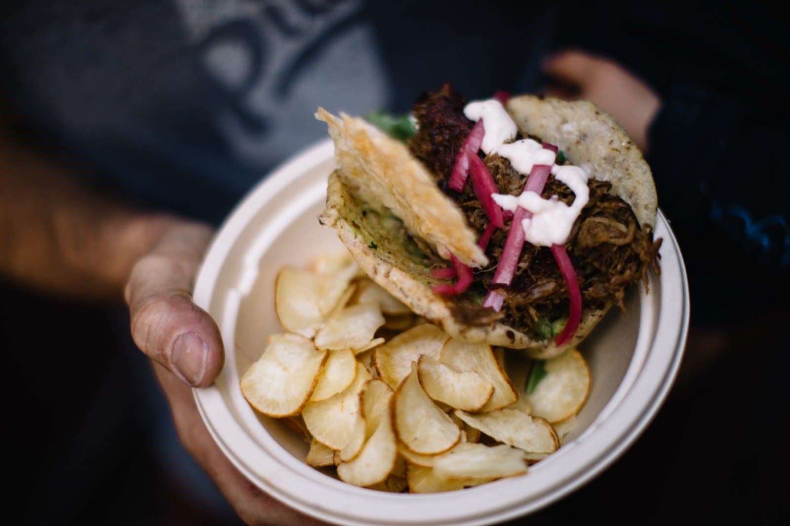 Arepa la Señorita: a handmade corn arepa filled with pulled lamb, served with yucca chips.